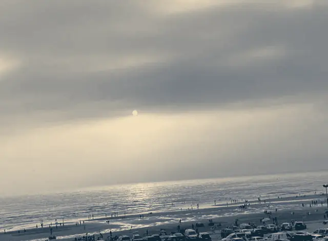 Hazy late light over the sea and Anza beach, seen through a sea-view room window (toned photograph)