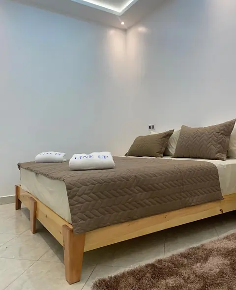 Double room with private bathroom at Line Up: a wide bed with LINE UP towels in a clean white room